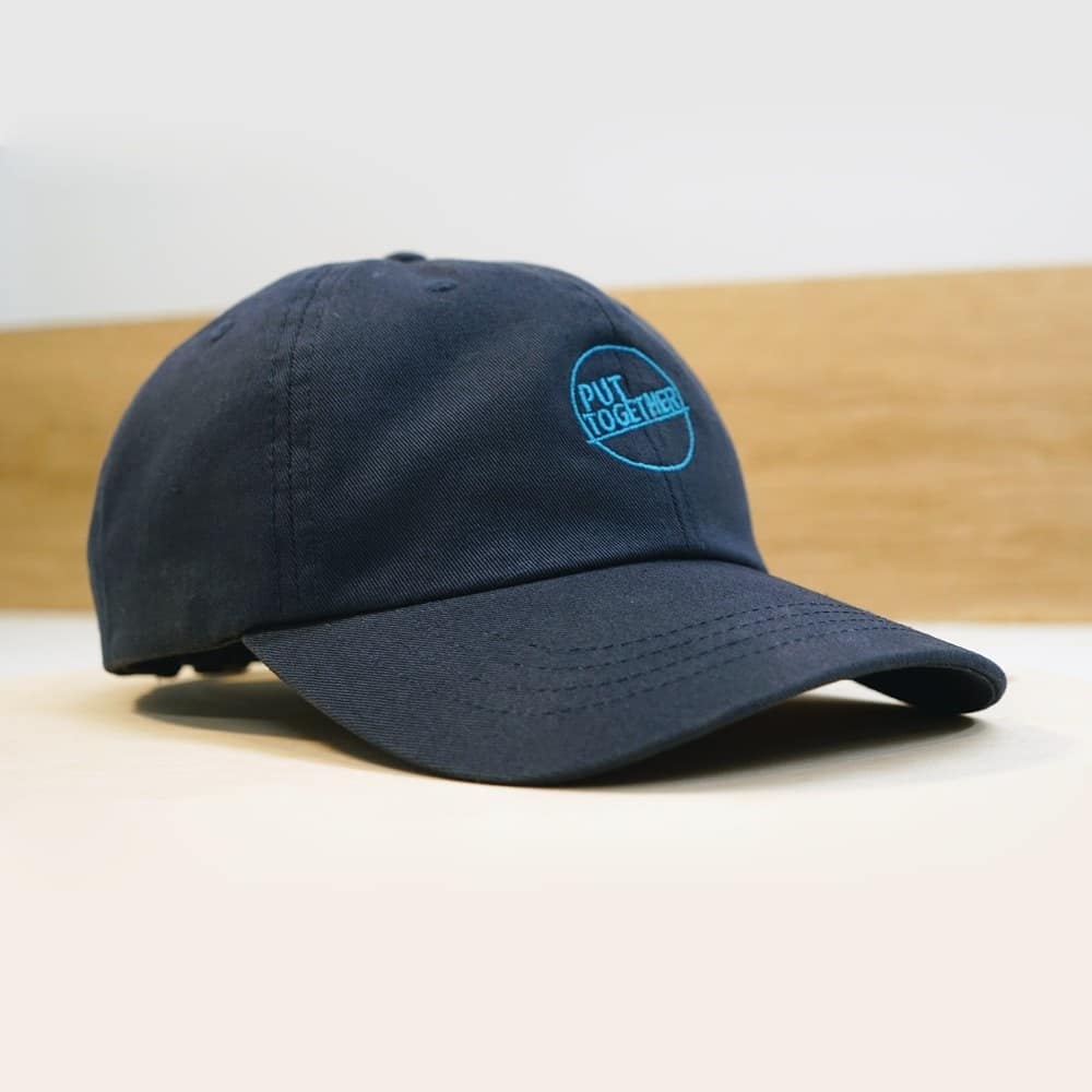 June 17th, 2021: Presenting our Put Together baseball cap! These hats will be available on our store in very limited supply tomorrow (6/18)! Featuring a high quality, embroidered Put Together logo and easily adjustable strap to fit anyone, our navy blue caps will be a perfect addition to any summer fit!